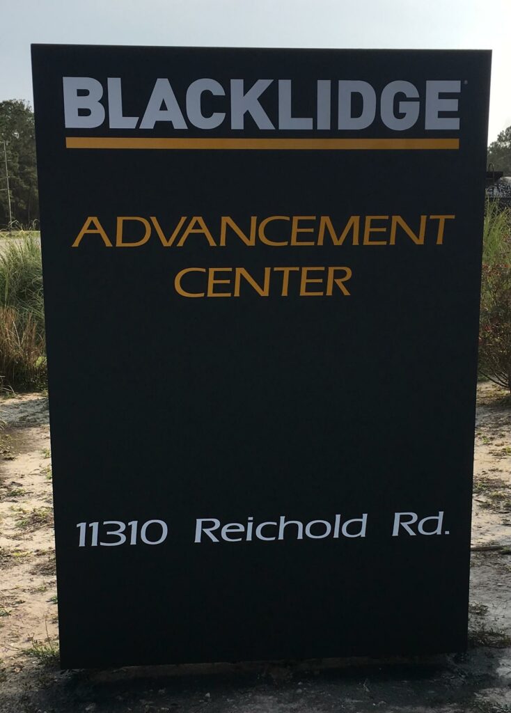 Ron Corder Customs A sign for blacklide advancement center in front of a building.