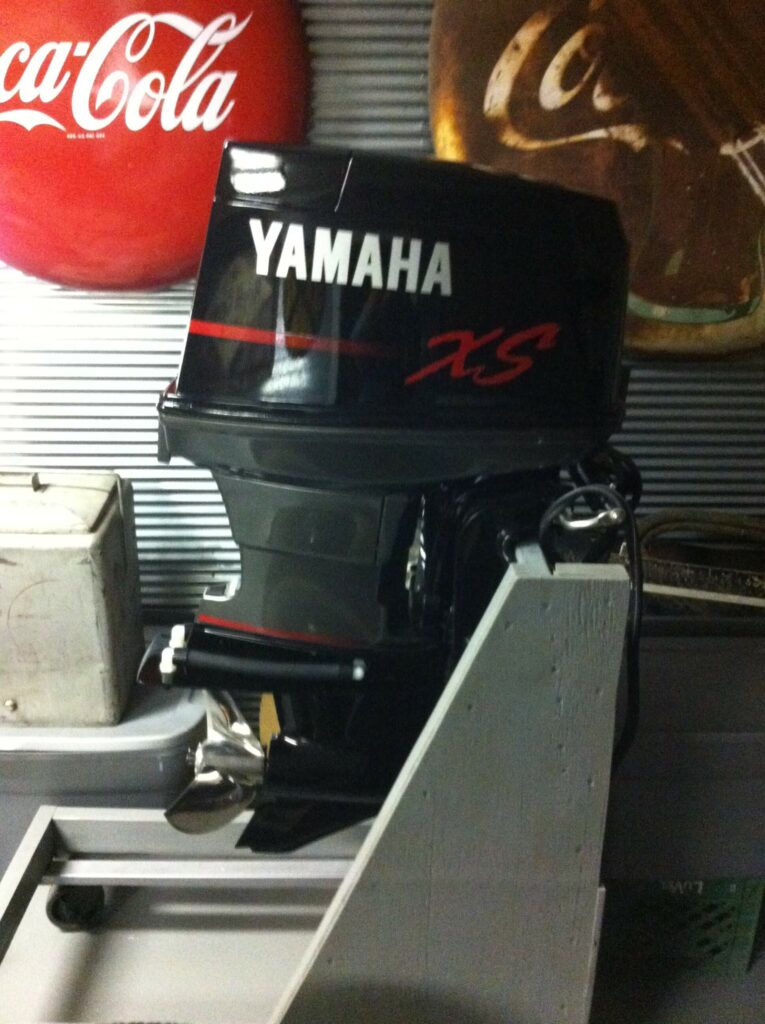 Ron Corder Customs A yamaha outboard motor sits in a garage.