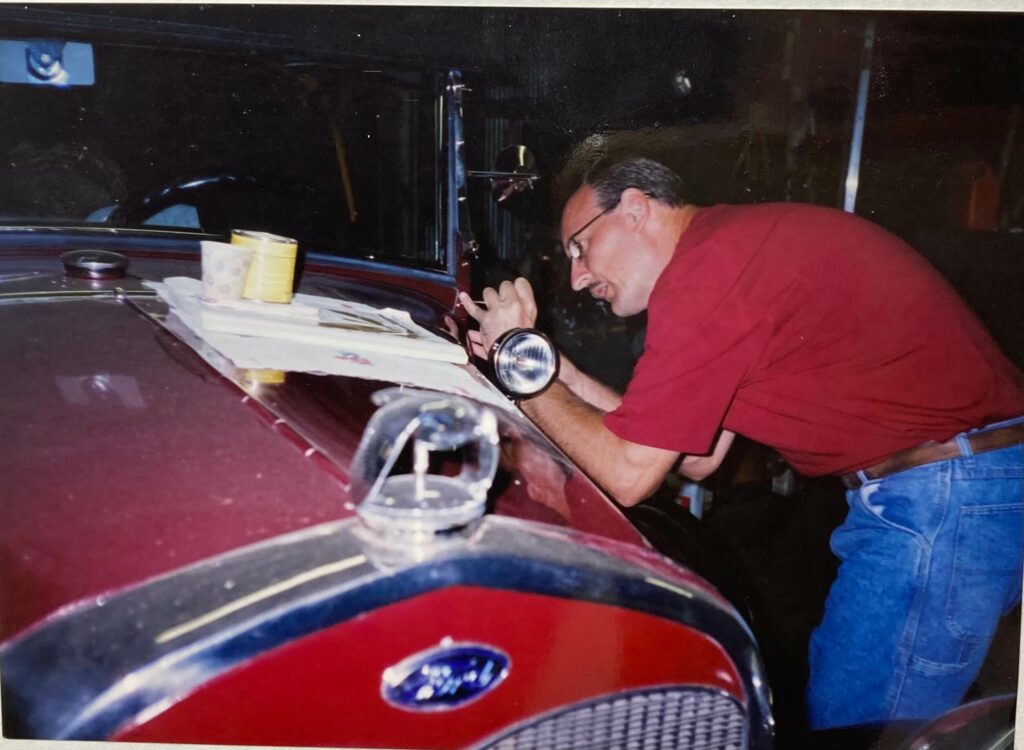 Ron Corder Customs A man working on a car in a garage.