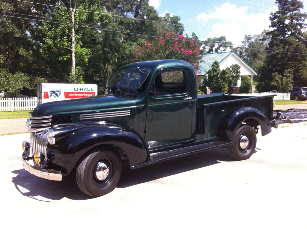 Ron Corder Customs A green truck parked in a parking lot.