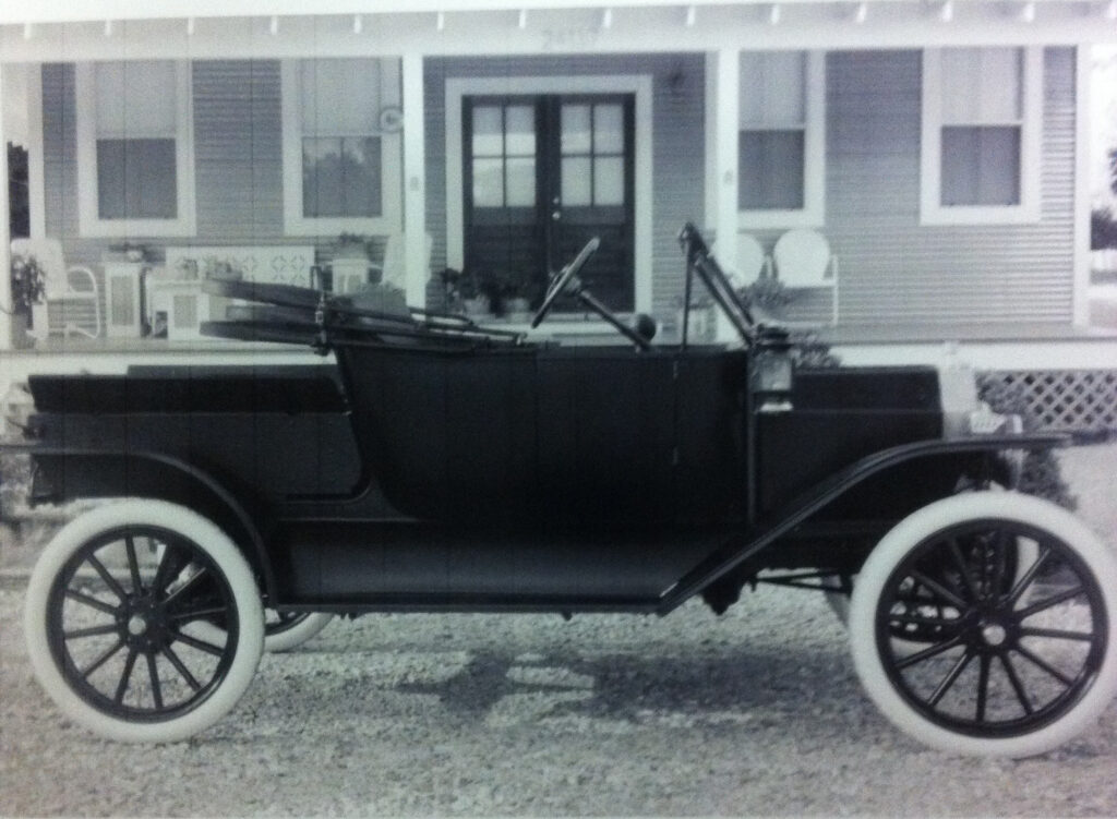 Ron Corder Customs A black and white photo of an old car in front of a house.