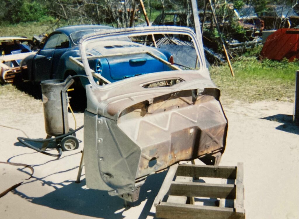 Ron Corder Customs A car is sitting on a trailer in a field.