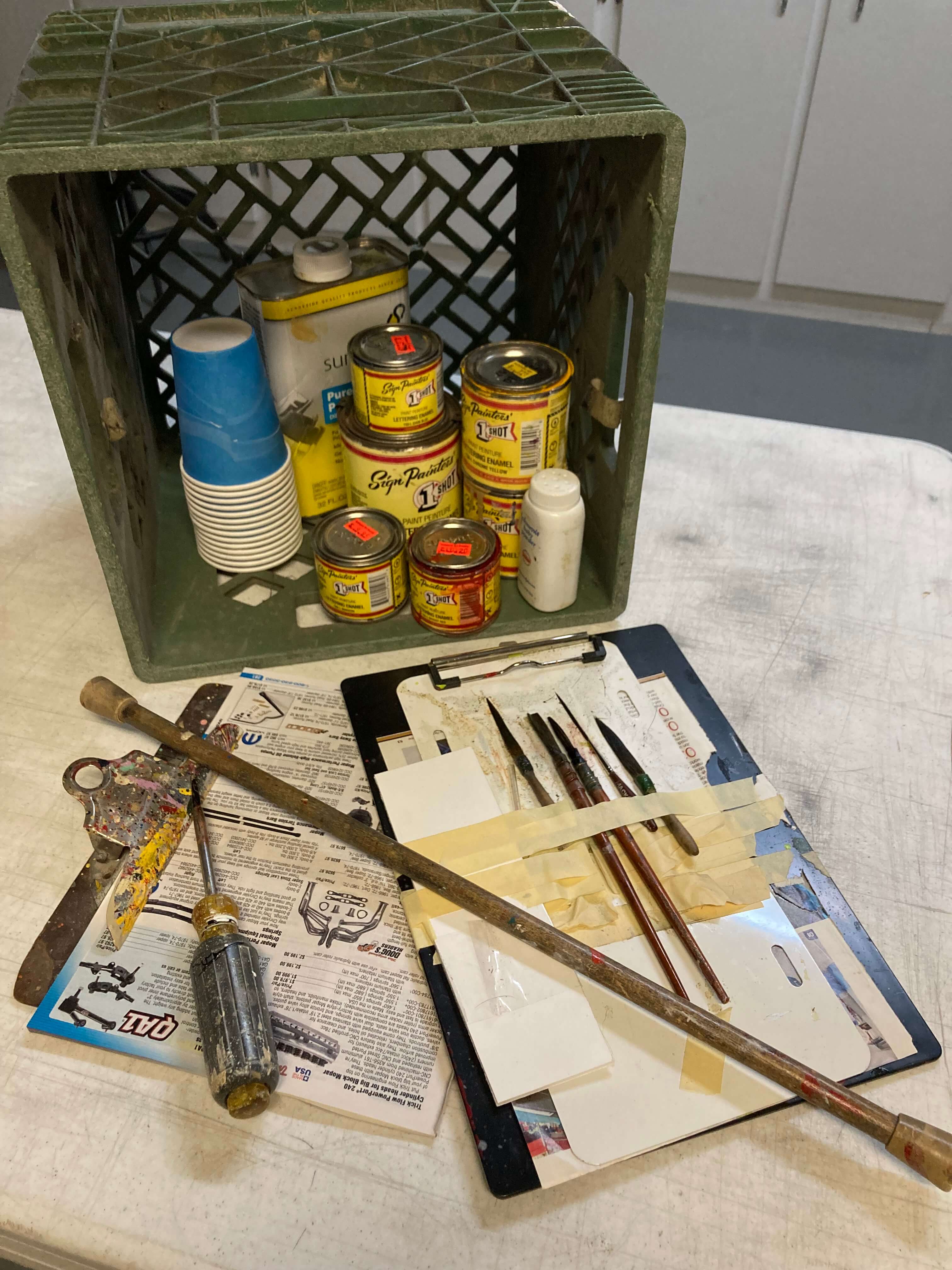 Ron Corder Customs A crate full of painting tools and supplies on a table.