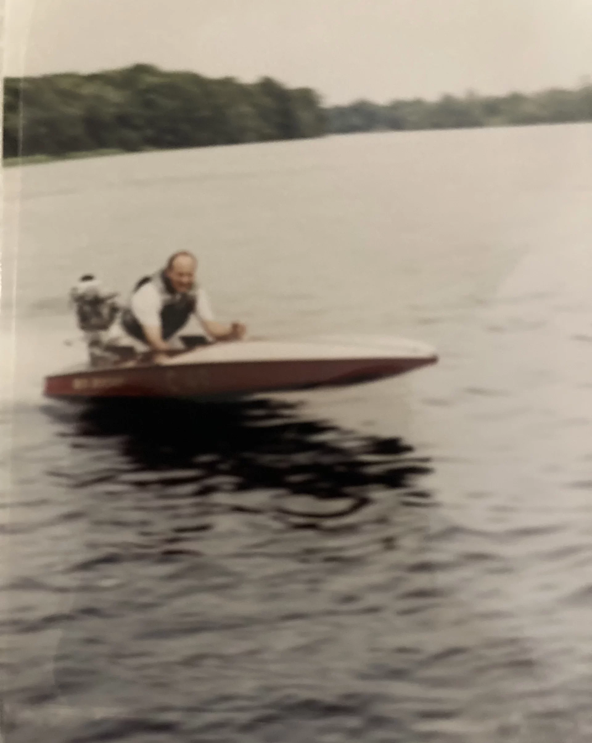 Ron Corder Customs An old photo of a man riding a small speed boat.